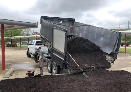 A dump truck pouring out mulch at a commercial site in Central Illinois