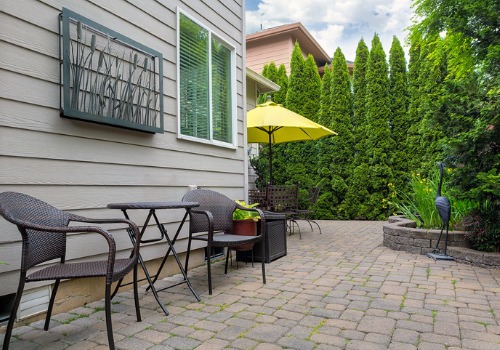 paver patio bricks with patio furniture and a yellow umbrella