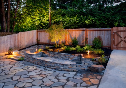 Paver patio in a backyard with a wood fence for Hardscaping Morton IL