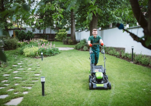 A team member from Mobeck Lawn & Landscape mows in an Outdoor Living Space in Morton IL