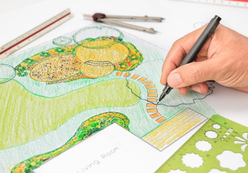 A landscape architect draws a garden plan, which is what a Landscaping Services Near You might do