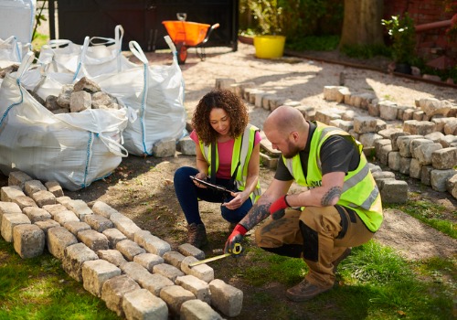 Team members measure stone as they finish services for a customer searching for a Landscaper in Morton IL